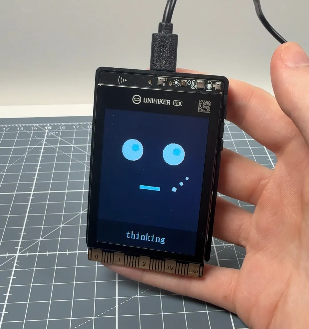 The UNIHIKER K10 displaying a custom facial expression